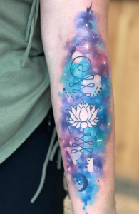 Watercolorgalaxy style bass cleff tattoo on the
